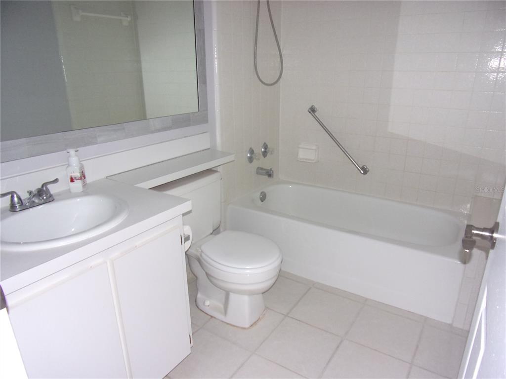1345 Pine Ridge Circle East, Unit C2 Tarpon Springs, FL 34688 - Photo 15 of 22 a bathroom with a sink toilet and shower