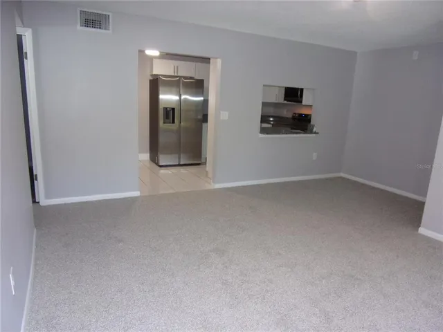 a view of a livingroom with an empty space and a flat screen tv