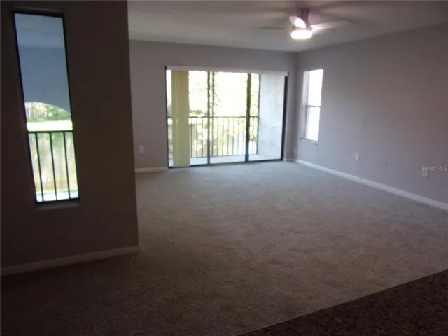 a view of an empty room with windows