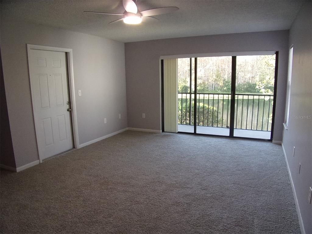 1345 Pine Ridge Circle East, Unit C2 Tarpon Springs, FL 34688 - Photo 10 of 22 a view of an empty room with windows