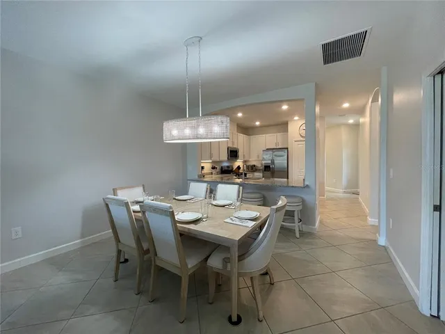 a living room with furniture a chandelier and a window