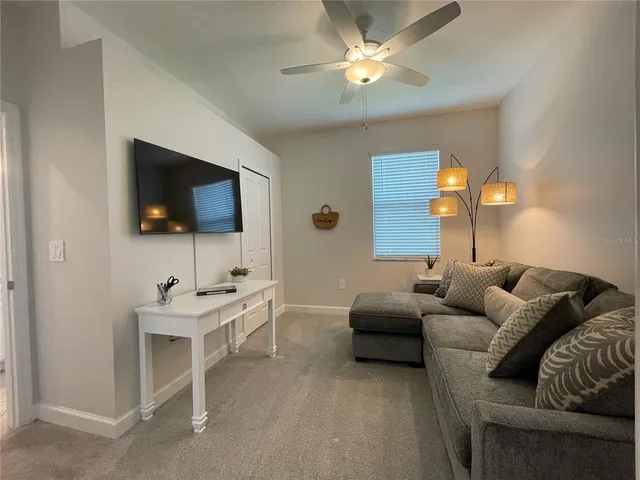 a living room with furniture and a chandelier