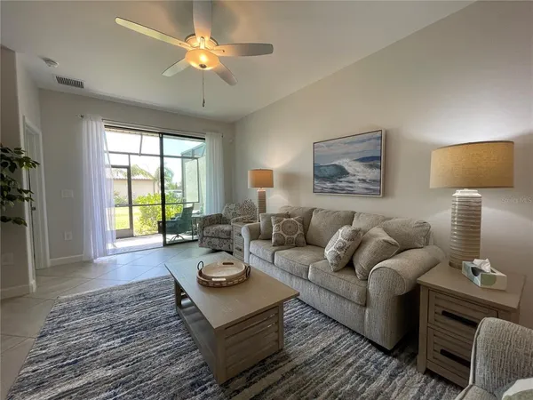 a bathroom with a granite countertop double vanity and a mirror