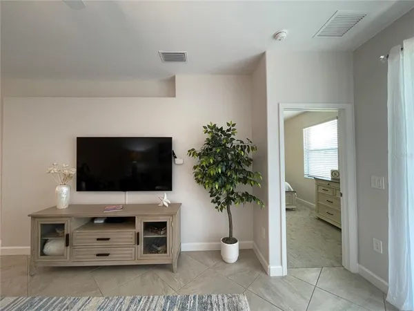 a view of a dining room with furniture a chandelier and wooden floor