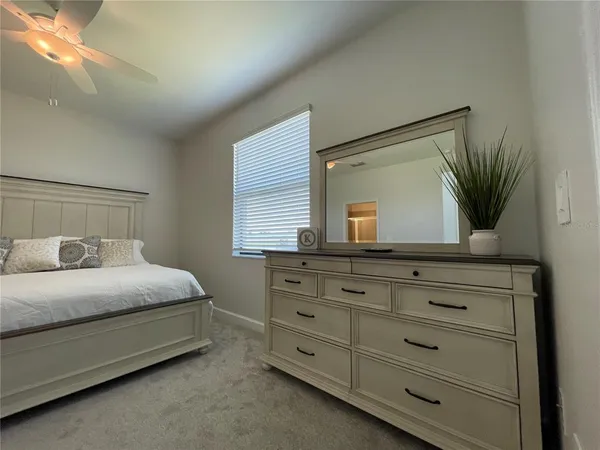 a view of a porch with furniture and a yard