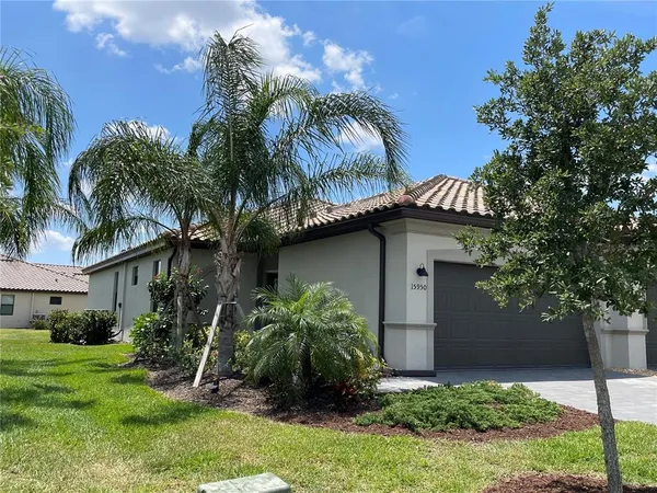a front view of a house with a lot of flowers