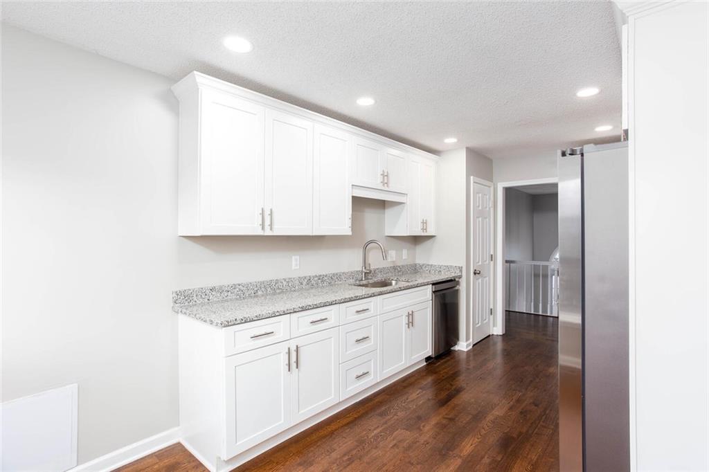 3162 Hadrian Court Powder Springs, GA 30127 - Photo 12 of 49 a kitchen with a sink stove and cabinets