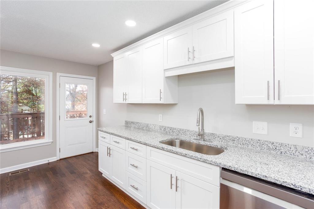 3162 Hadrian Court Powder Springs, GA 30127 - Photo 16 of 49 a kitchen with granite countertop white cabinets and a sink