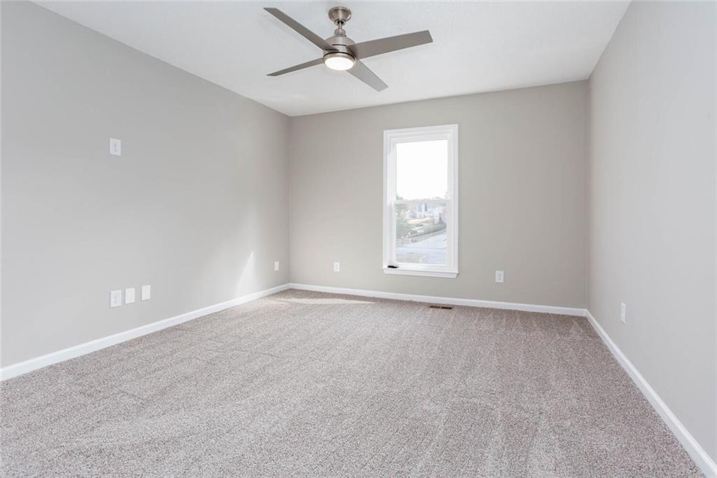 3162 Hadrian Court Powder Springs, GA 30127 - Photo 20 of 49 an empty room with windows and fan