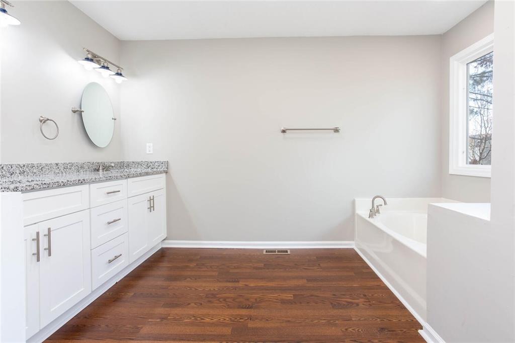 3162 Hadrian Court Powder Springs, GA 30127 - Photo 28 of 49 a spacious bathroom with a granite countertop sink mirror and bathtub