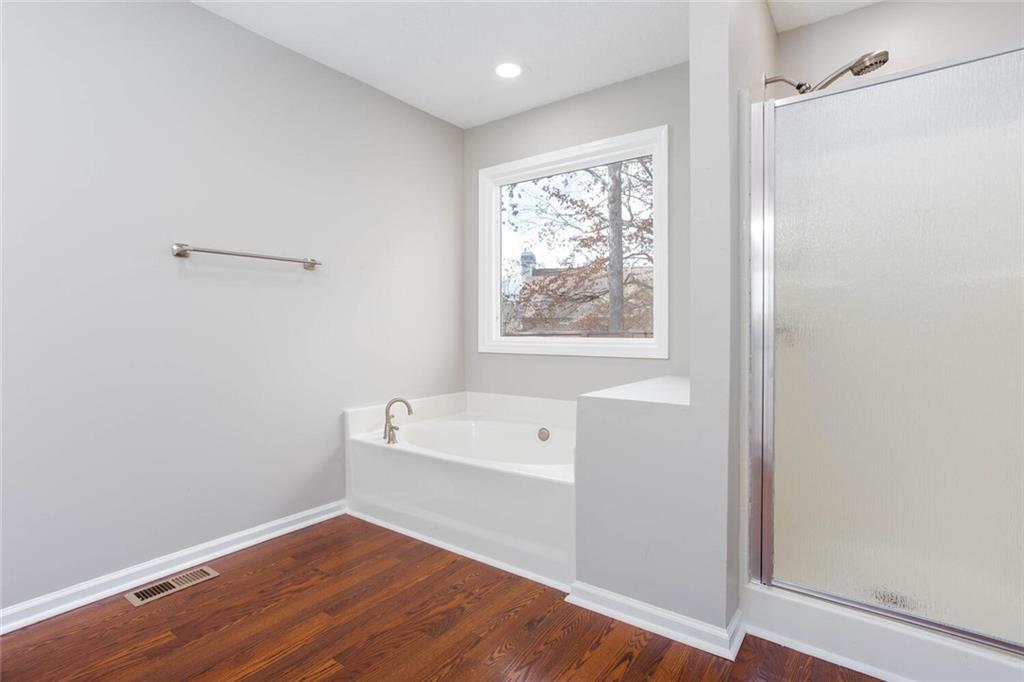 3162 Hadrian Court Powder Springs, GA 30127 - Photo 29 of 49 a view of an empty room with wooden floor and a window