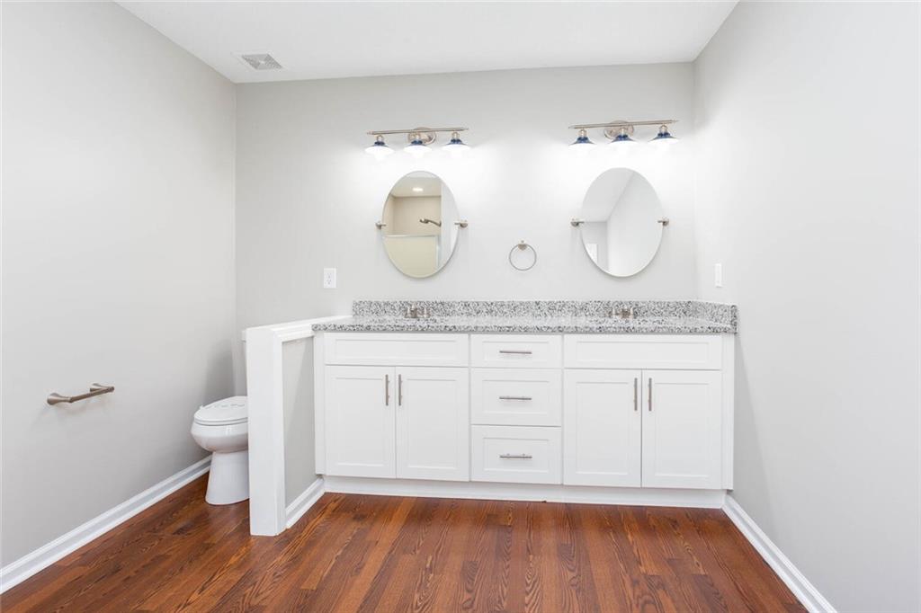 3162 Hadrian Court Powder Springs, GA 30127 - Photo 30 of 49 a bathroom with a granite countertop toilet sink and mirror