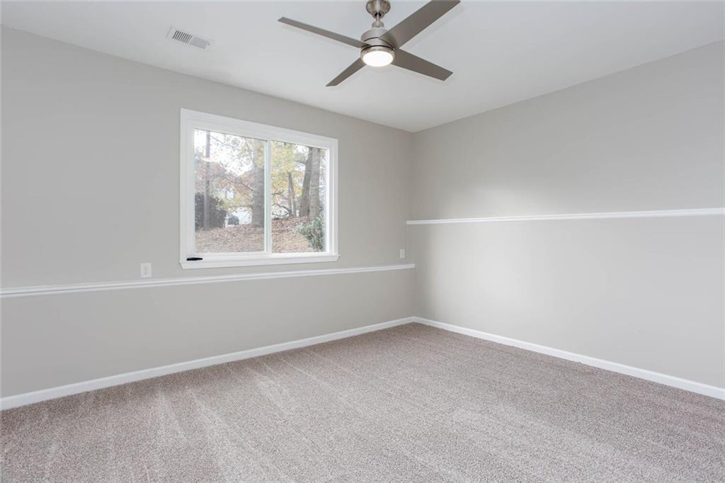 3162 Hadrian Court Powder Springs, GA 30127 - Photo 36 of 49 an empty room with a window and a fan