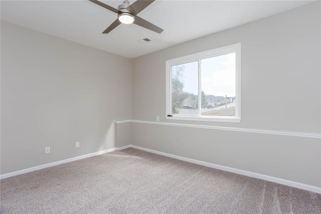 3162 Hadrian Court Powder Springs, GA 30127 - Photo 37 of 49 an empty room with a window and a fan