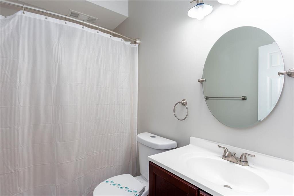 3162 Hadrian Court Powder Springs, GA 30127 - Photo 38 of 49 a bathroom with a sink mirror and a toilet