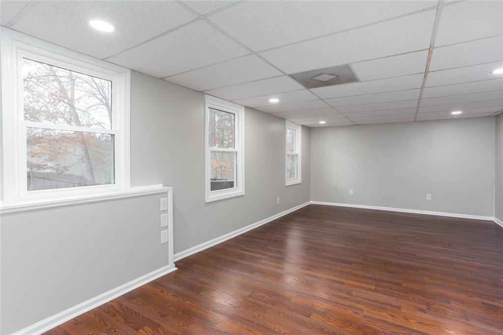 3162 Hadrian Court Powder Springs, GA 30127 - Photo 42 of 49 an empty room with wooden floor and windows