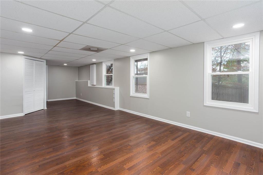 3162 Hadrian Court Powder Springs, GA 30127 - Photo 43 of 49 a view of an empty room with wooden floor and a window