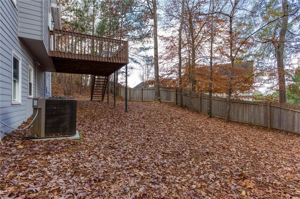 3162 Hadrian Court Powder Springs, GA 30127 - Photo 45 of 49 a view of a backyard with large tree and wooden fence