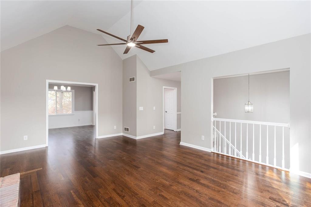 3162 Hadrian Court Powder Springs, GA 30127 - Photo 8 of 49 a view of an empty room with wooden floor and a ceiling fan
