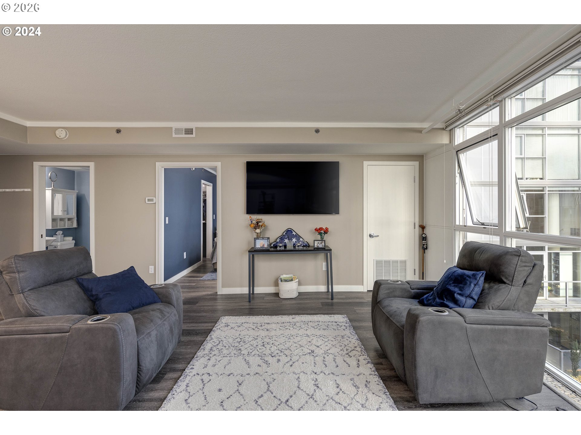 533 Northeast Holladay Street, Unit 409 Portland, OR 97232 - Photo 11 of 38 a living room with furniture and a flat screen tv