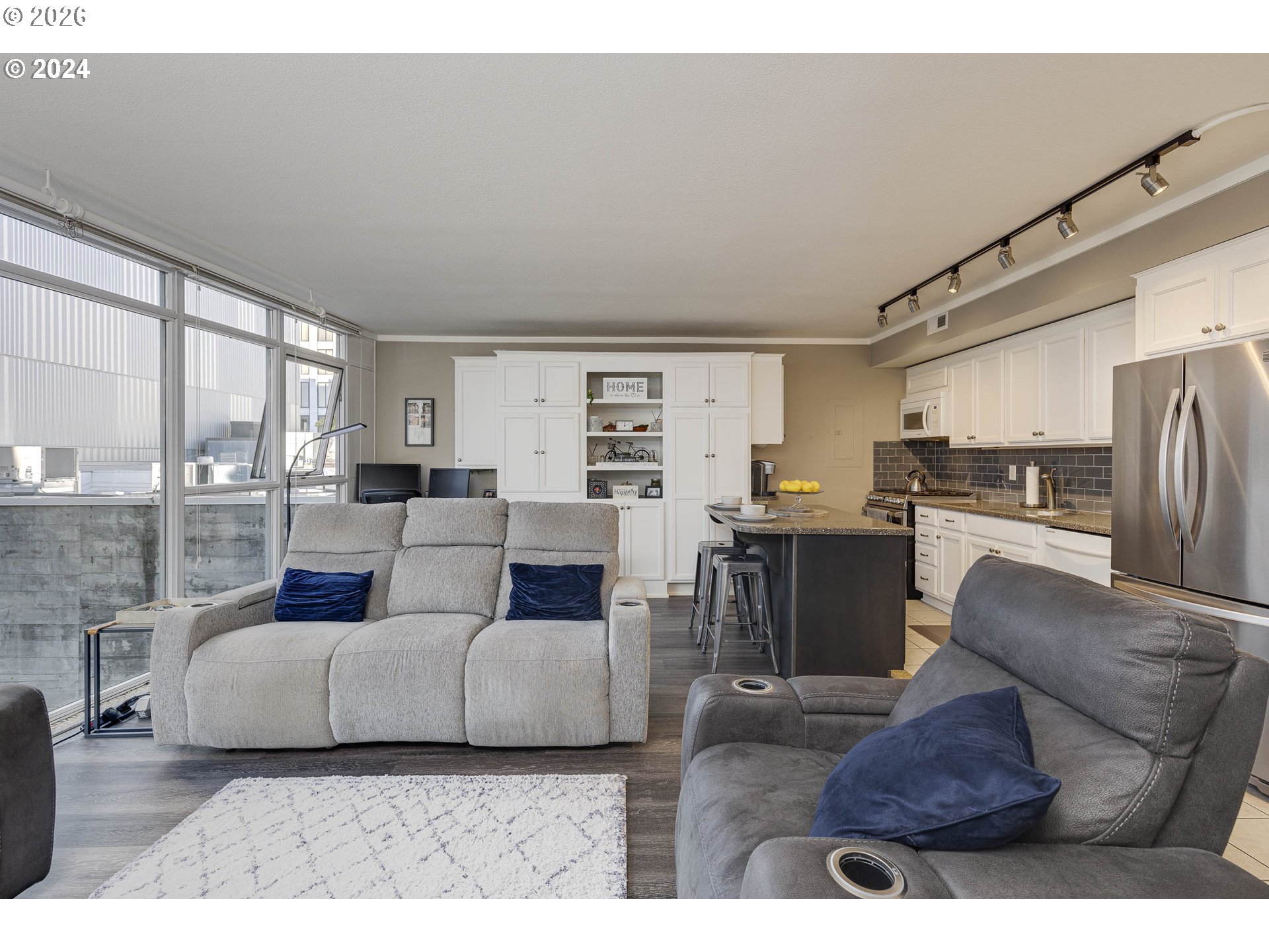 533 Northeast Holladay Street, Unit 409 Portland, OR 97232 - Photo 13 of 38 a living room with furniture and a large window