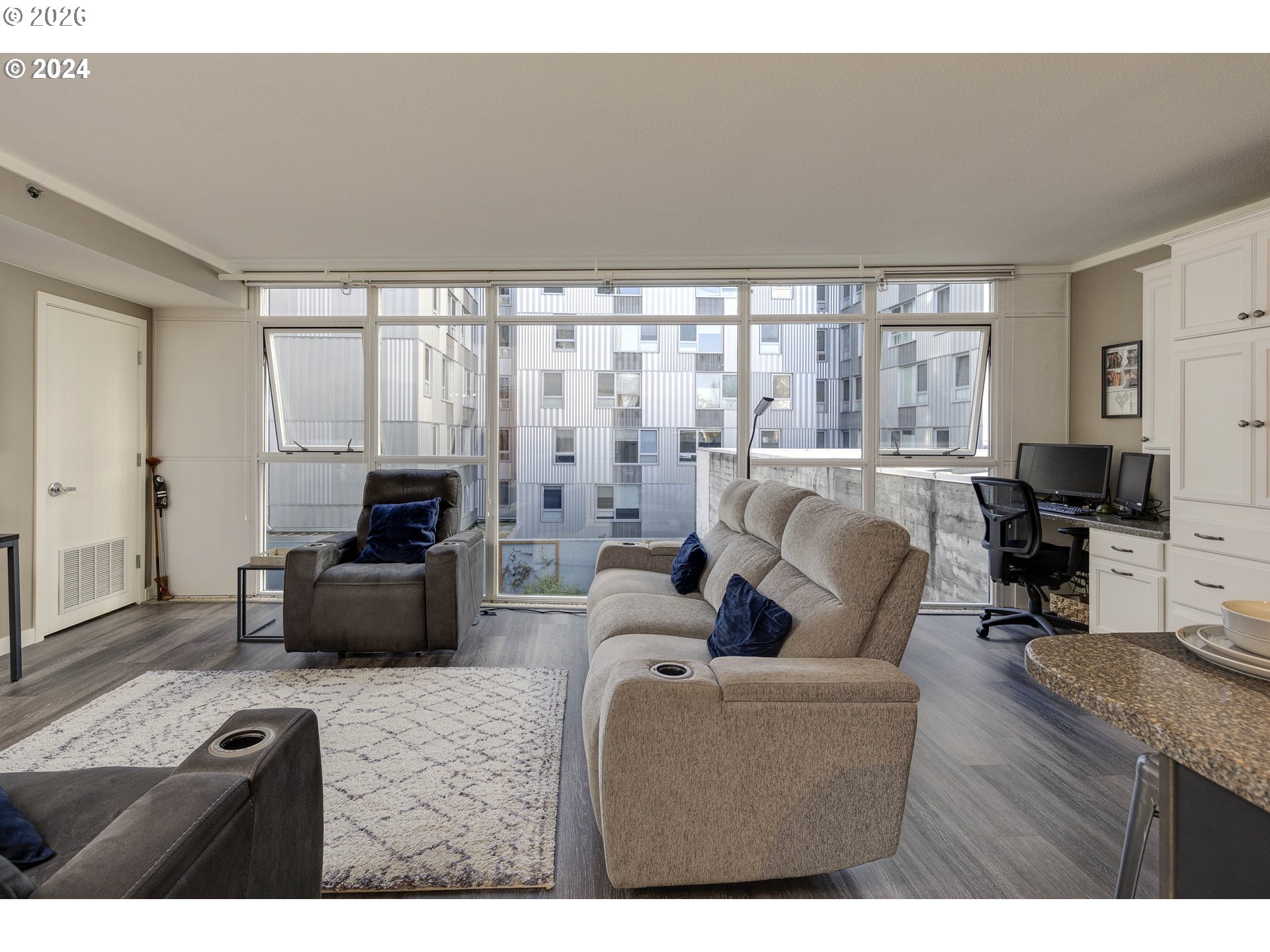 533 Northeast Holladay Street, Unit 409 Portland, OR 97232 - Photo 14 of 38 a living room with furniture a large window and a flat screen tv