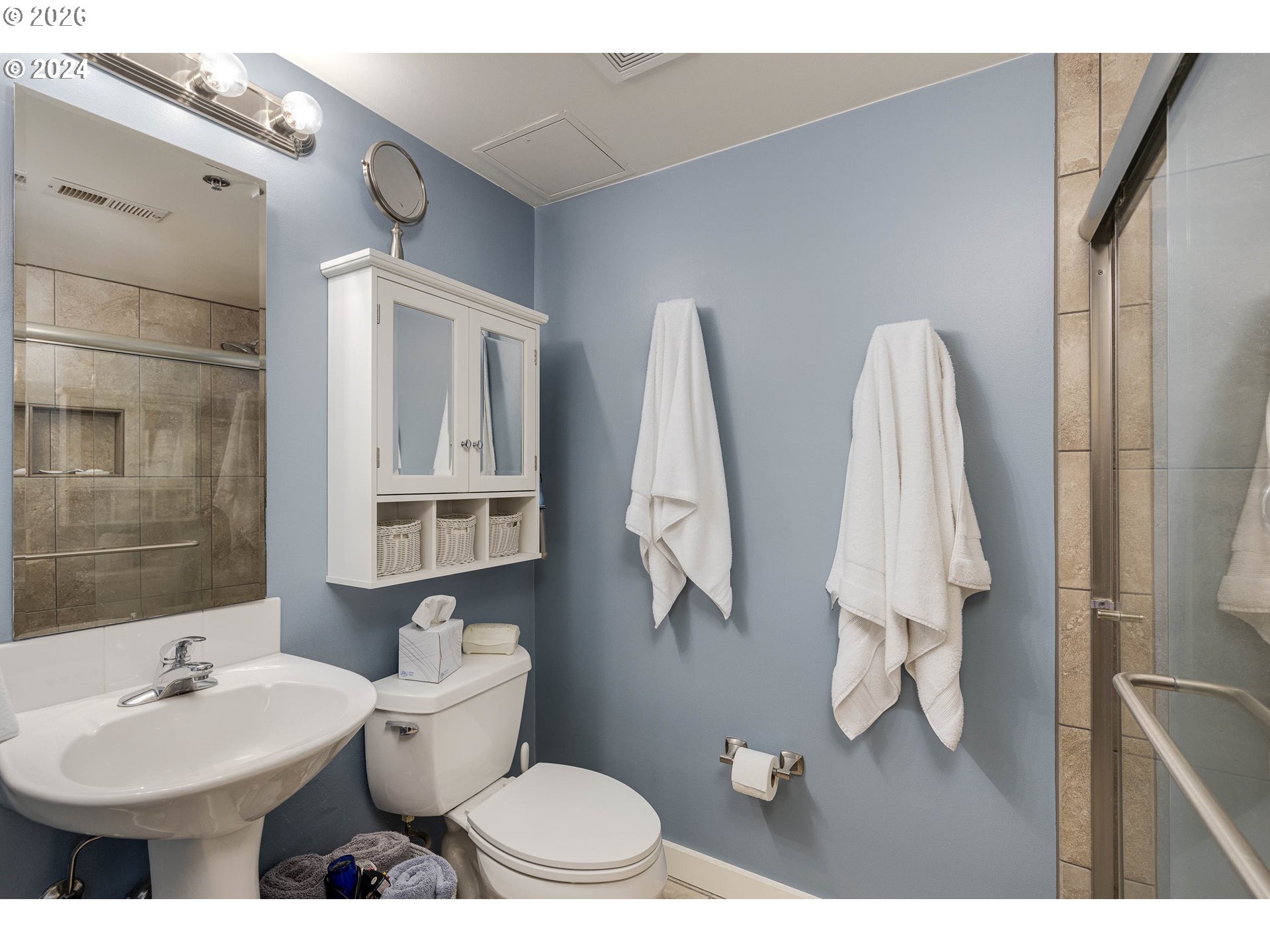 533 Northeast Holladay Street, Unit 409 Portland, OR 97232 - Photo 15 of 38 a bathroom with a toilet sink and mirror