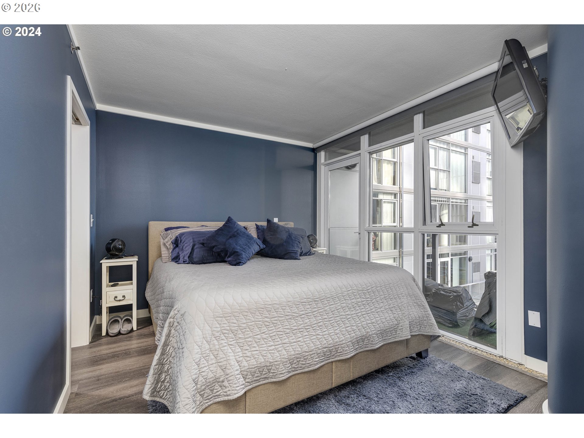 533 Northeast Holladay Street, Unit 409 Portland, OR 97232 - Photo 18 of 38 a bedroom with a bed and a window