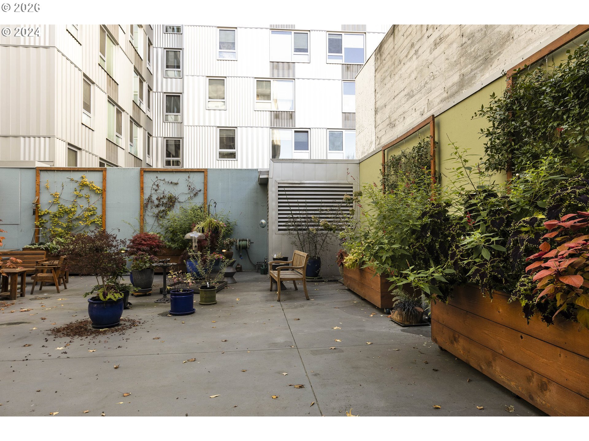 533 Northeast Holladay Street, Unit 409 Portland, OR 97232 - Photo 25 of 38 a view of a patio with plants and chairs