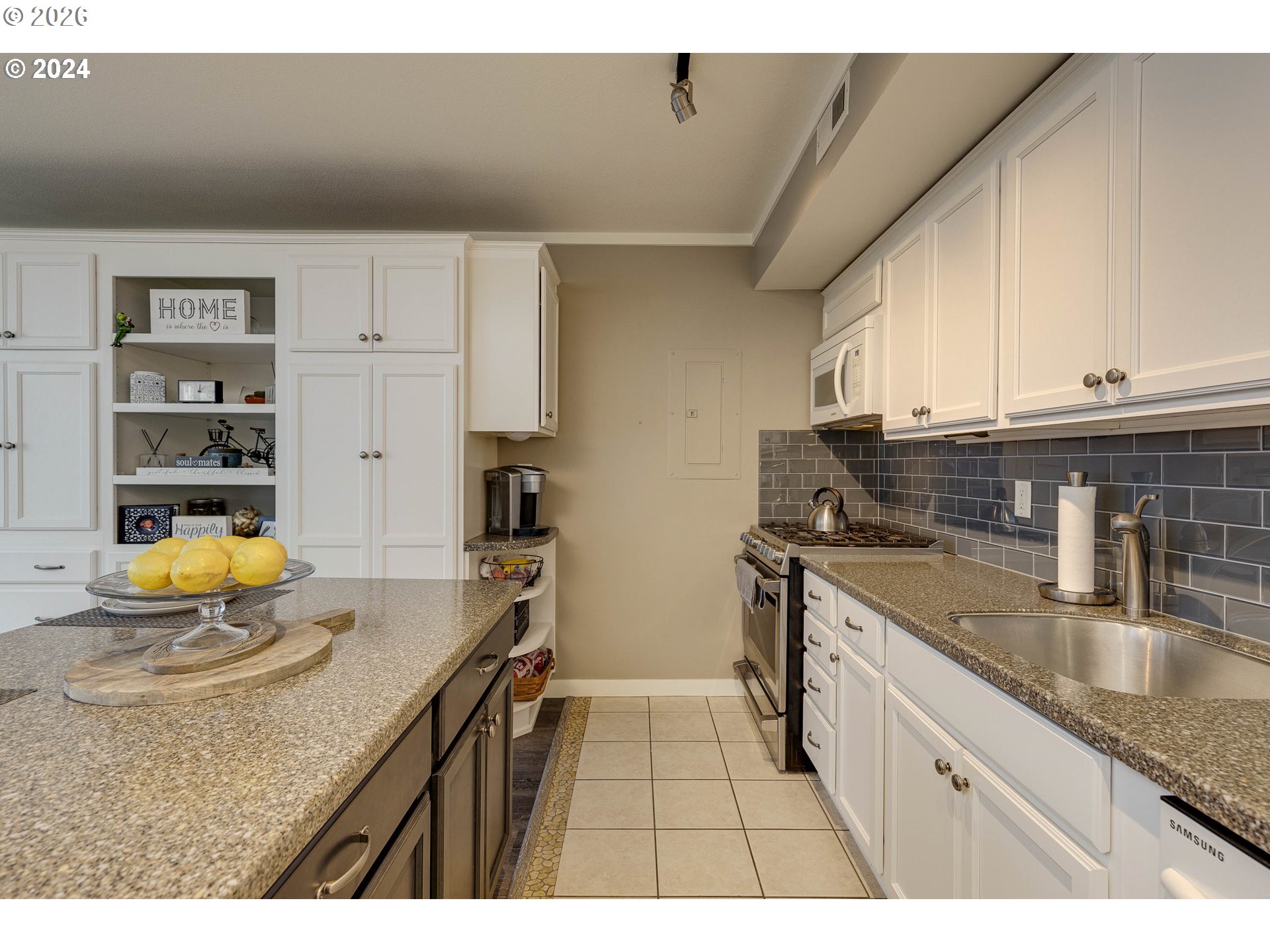 533 Northeast Holladay Street, Unit 409 Portland, OR 97232 - Photo 3 of 38 a kitchen with stainless steel appliances granite countertop a sink stove and cabinets