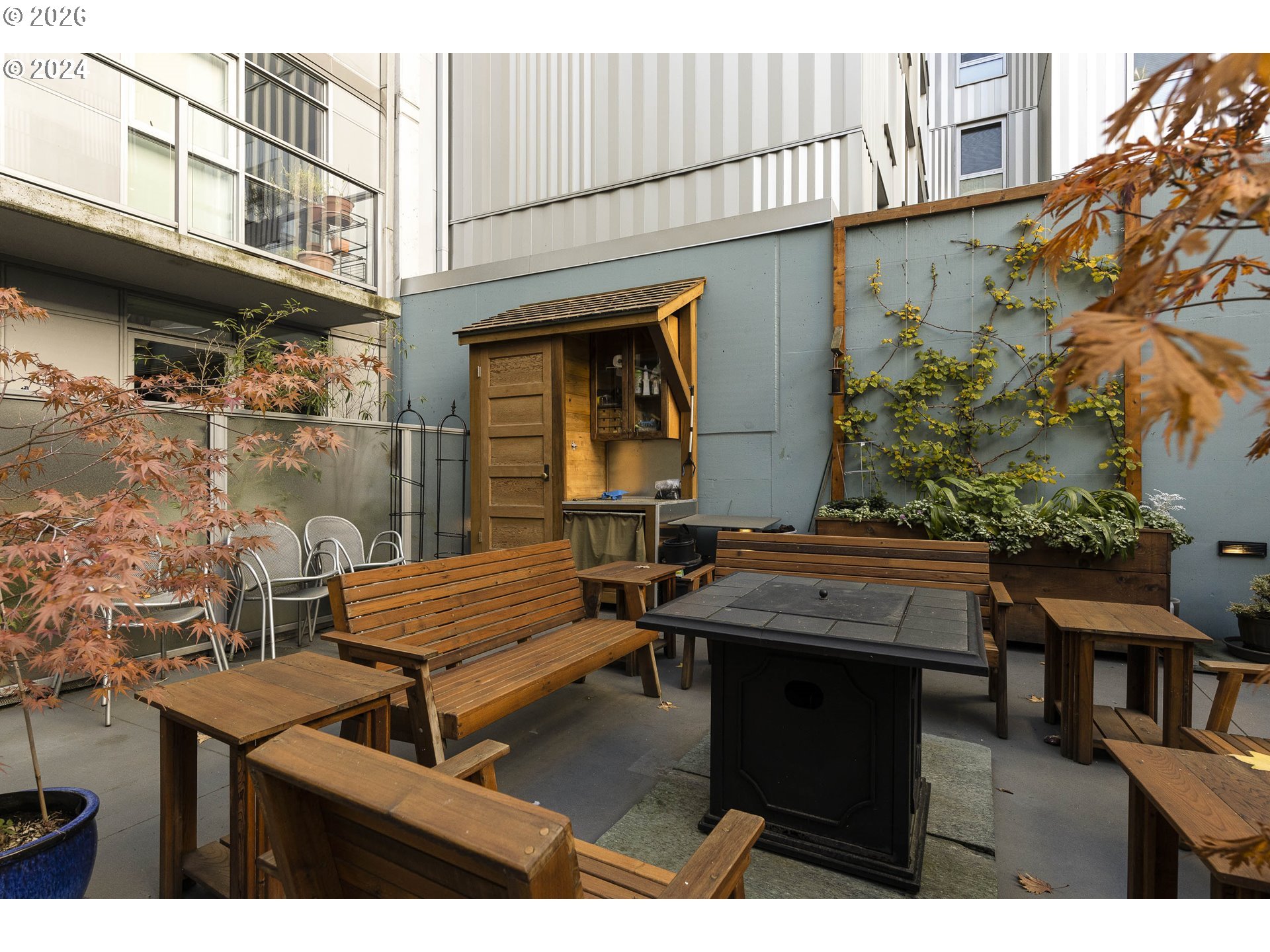 533 Northeast Holladay Street, Unit 409 Portland, OR 97232 - Photo 32 of 38 a couple of table and chairs in front of a building