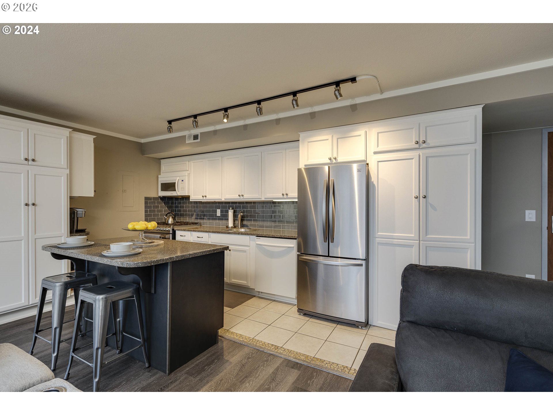 533 Northeast Holladay Street, Unit 409 Portland, OR 97232 - Photo 4 of 38 a kitchen with a sink refrigerator and cabinets