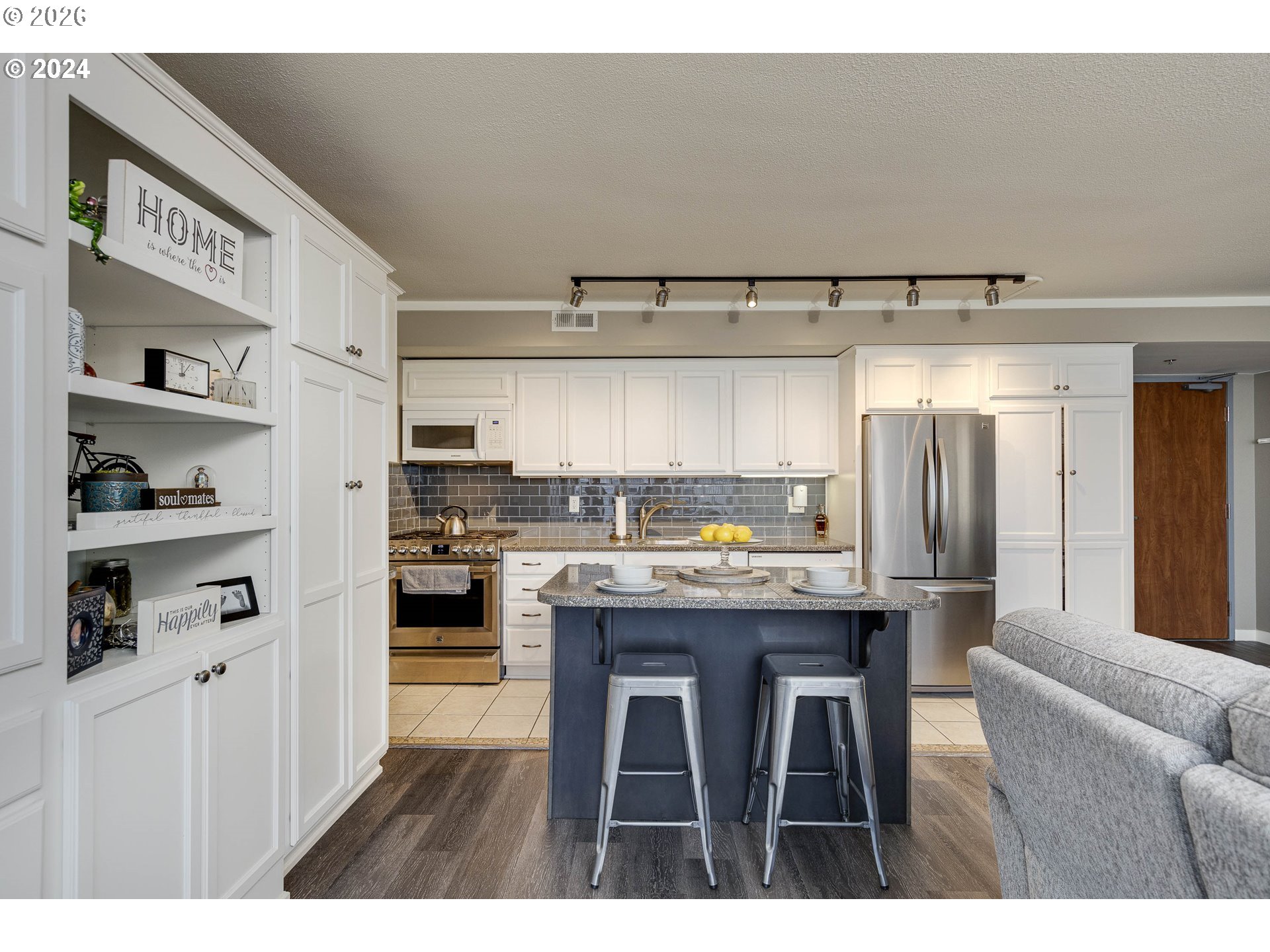 533 Northeast Holladay Street, Unit 409 Portland, OR 97232 - Photo 5 of 38 a view of kitchen with cabinets and wooden floor