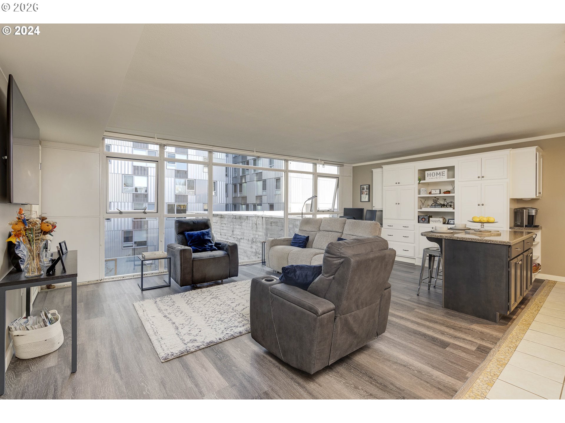 533 Northeast Holladay Street, Unit 409 Portland, OR 97232 - Photo 6 of 38 a living room with furniture and a flat screen tv