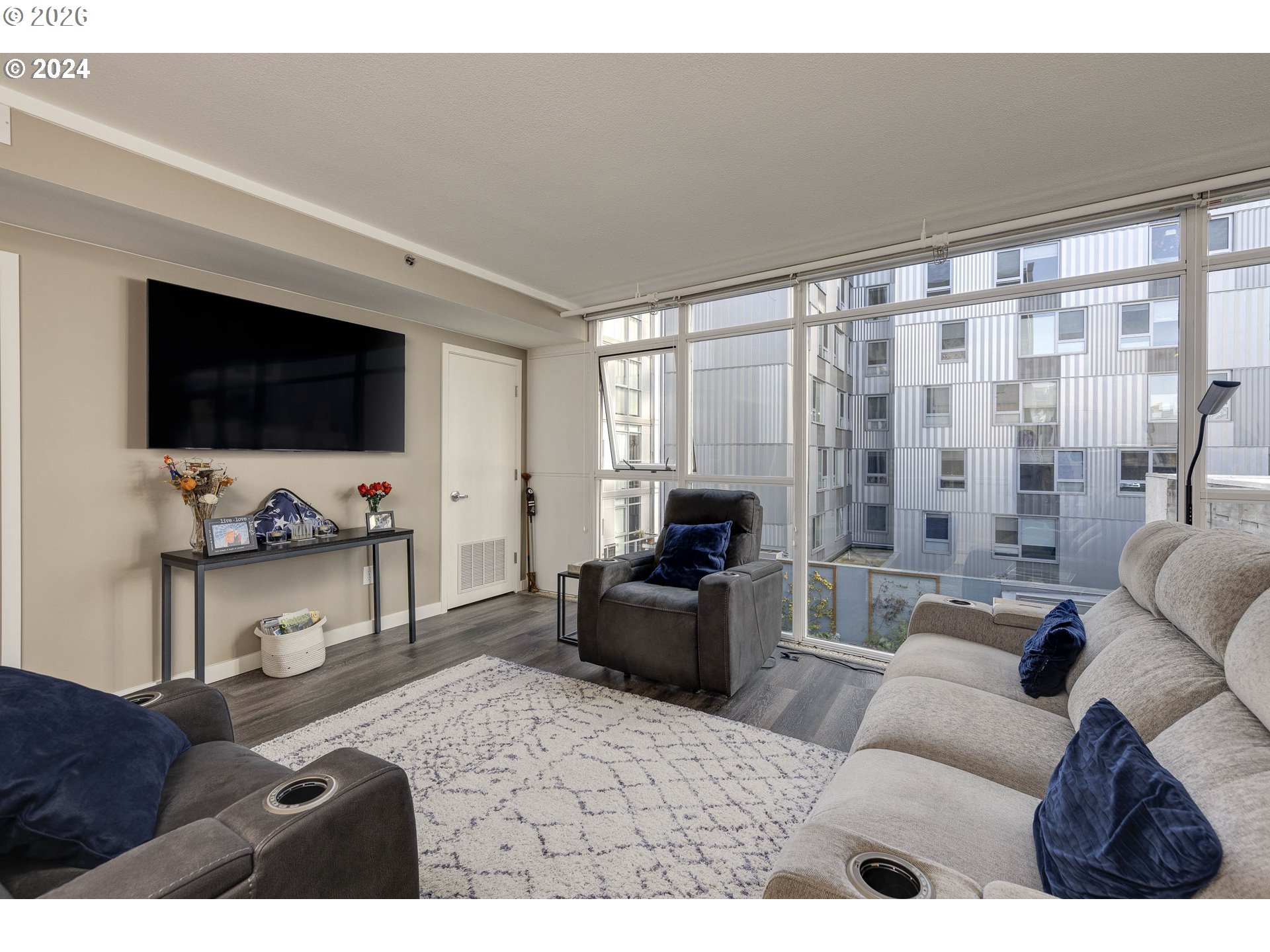 533 Northeast Holladay Street, Unit 409 Portland, OR 97232 - Photo 10 of 38 a living room with furniture and a flat screen tv
