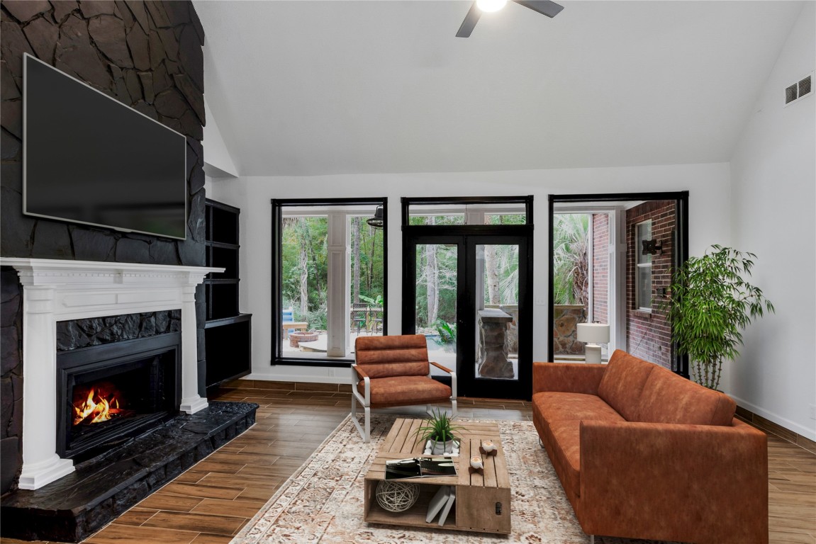40111 Roundup Road Magnolia, TX 77354 - Photo 11 of 42 a living room with furniture and a fireplace