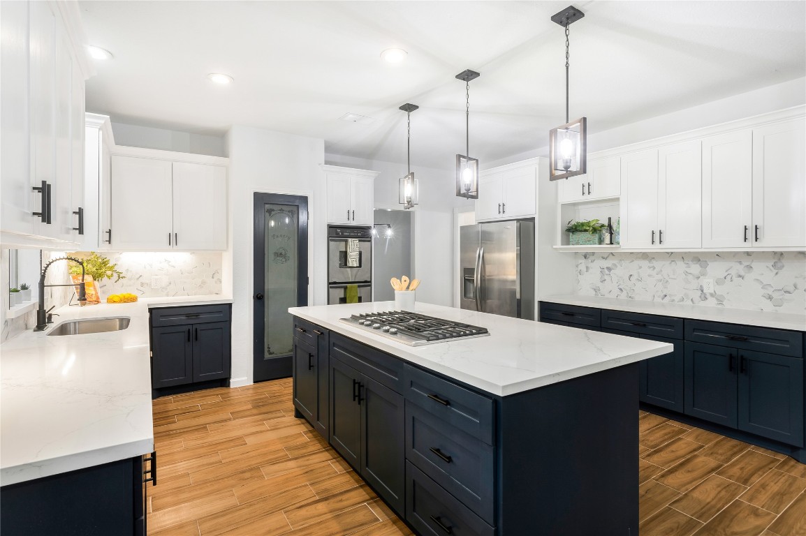 40111 Roundup Road Magnolia, TX 77354 - Photo 13 of 42 a kitchen with a refrigerator a sink and wooden floor