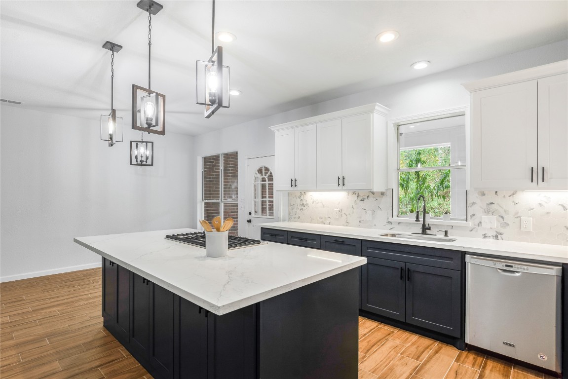 40111 Roundup Road Magnolia, TX 77354 - Photo 15 of 42 a kitchen with a sink a center island cabinets and a window