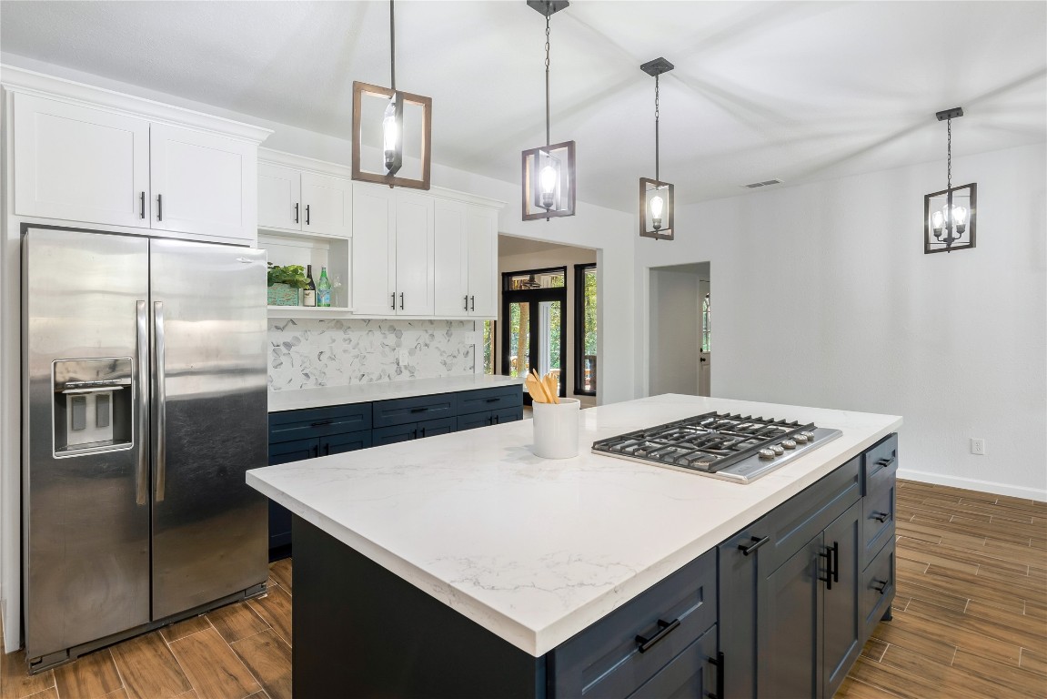 40111 Roundup Road Magnolia, TX 77354 - Photo 16 of 42 a kitchen with stainless steel appliances granite countertop a sink a refrigerator and a stove