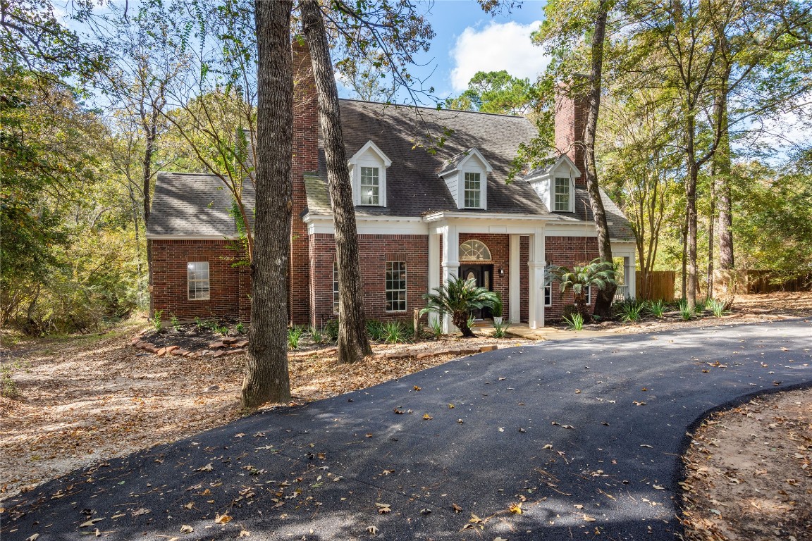 40111 Roundup Road Magnolia, TX 77354 - Photo 2 of 42 a view of a house with a tree in front