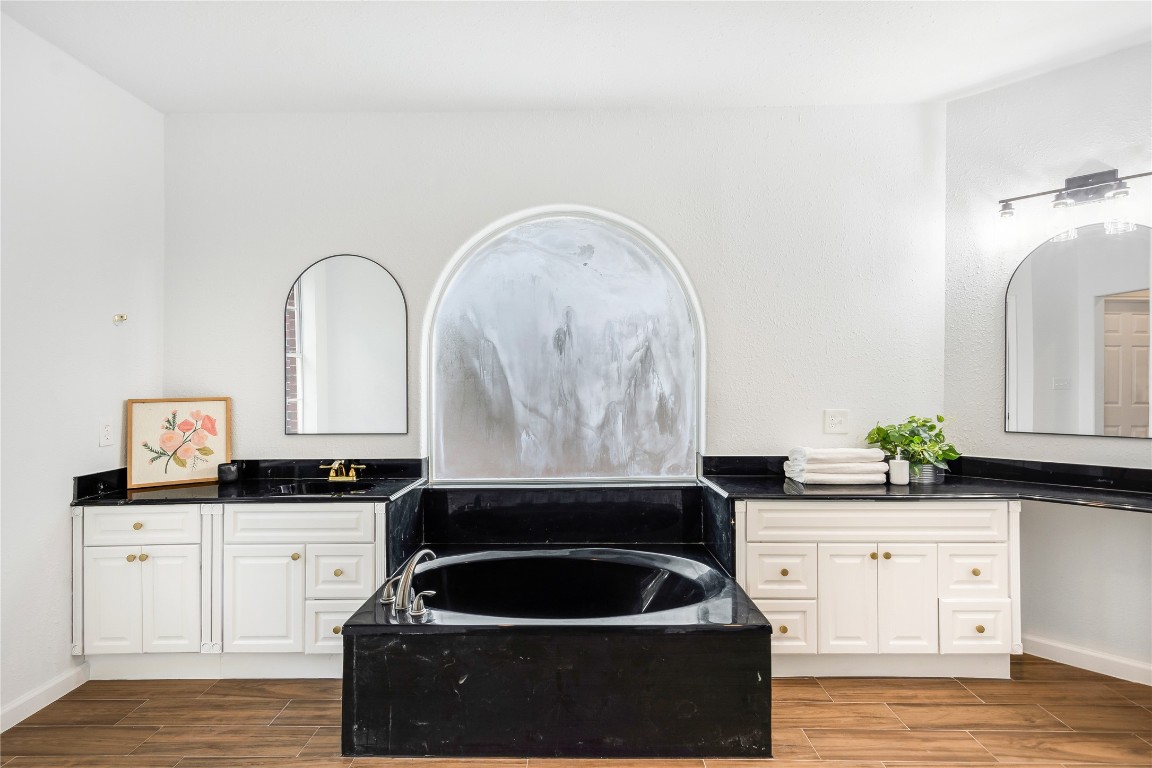 40111 Roundup Road Magnolia, TX 77354 - Photo 21 of 42 a kitchen with granite countertop a stove a sink and a microwave