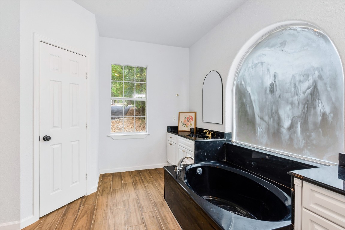 40111 Roundup Road Magnolia, TX 77354 - Photo 23 of 42 a bathroom with a sink and a mirror