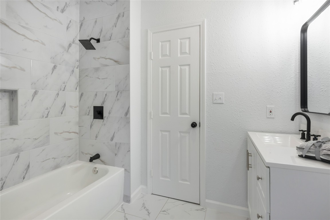 40111 Roundup Road Magnolia, TX 77354 - Photo 26 of 42 a bathroom with a bathtub and a sink
