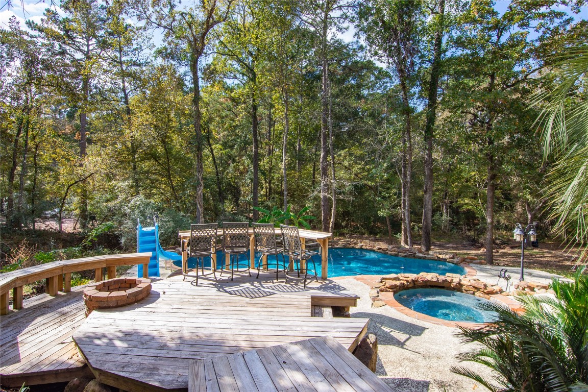 40111 Roundup Road Magnolia, TX 77354 - Photo 40 of 42 a view of backyard with swimming pool and seating space