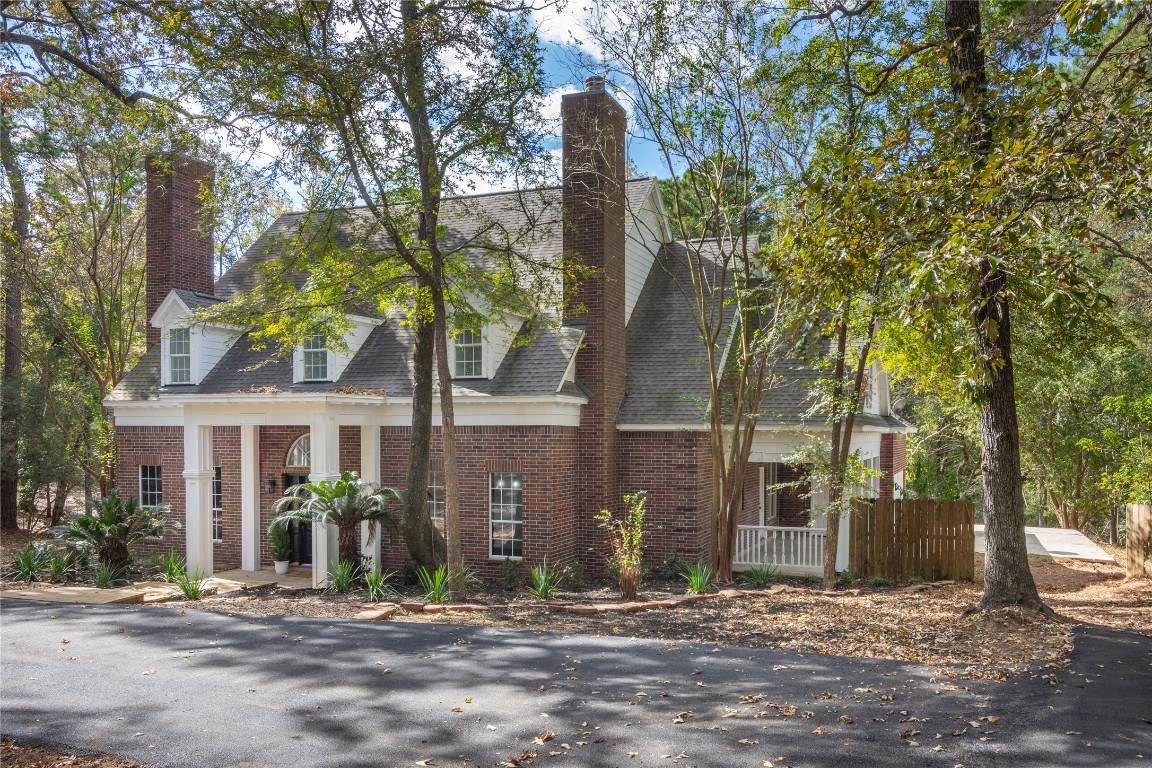 40111 Roundup Road Magnolia, TX 77354 - Photo 4 of 42 a front view of a house with a yard