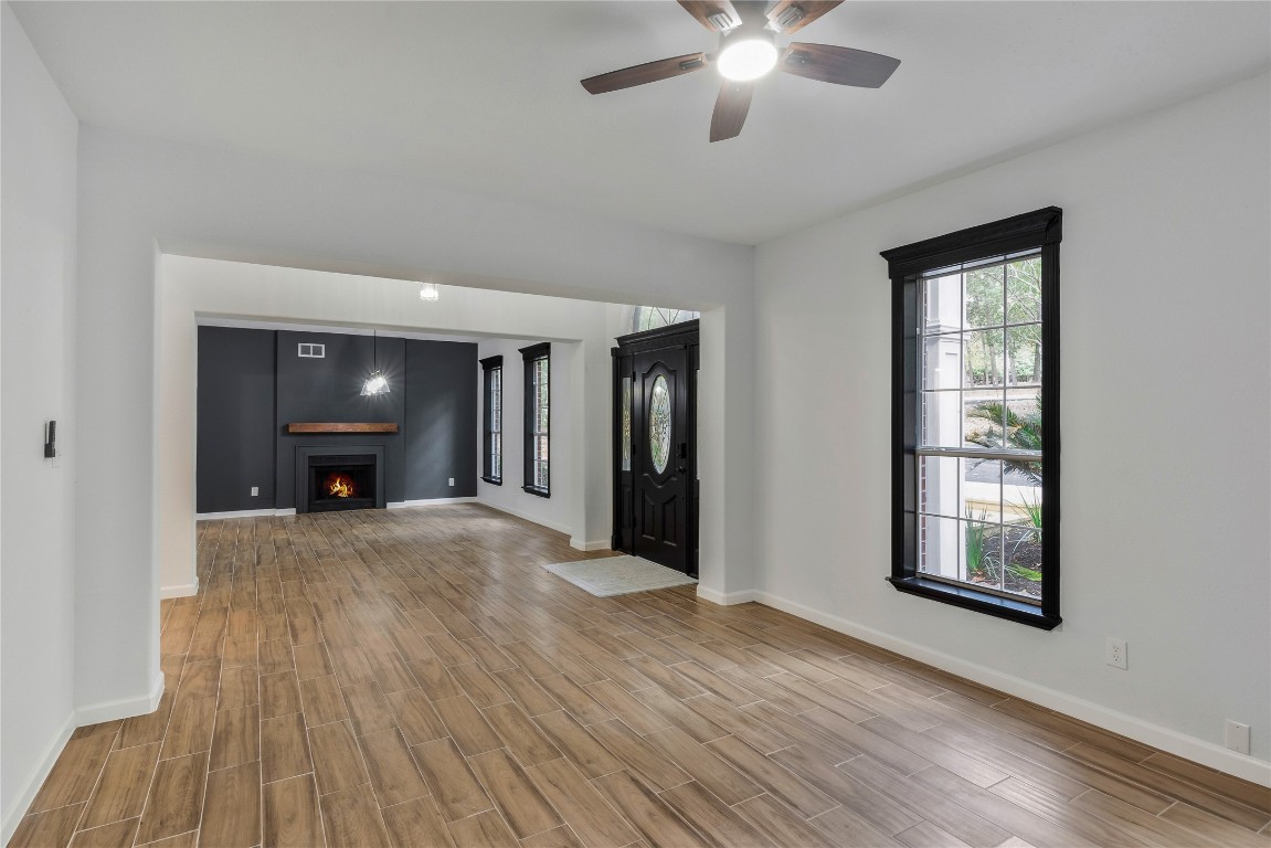 40111 Roundup Road Magnolia, TX 77354 - Photo 8 of 42 a view of an empty room with window and wooden floor
