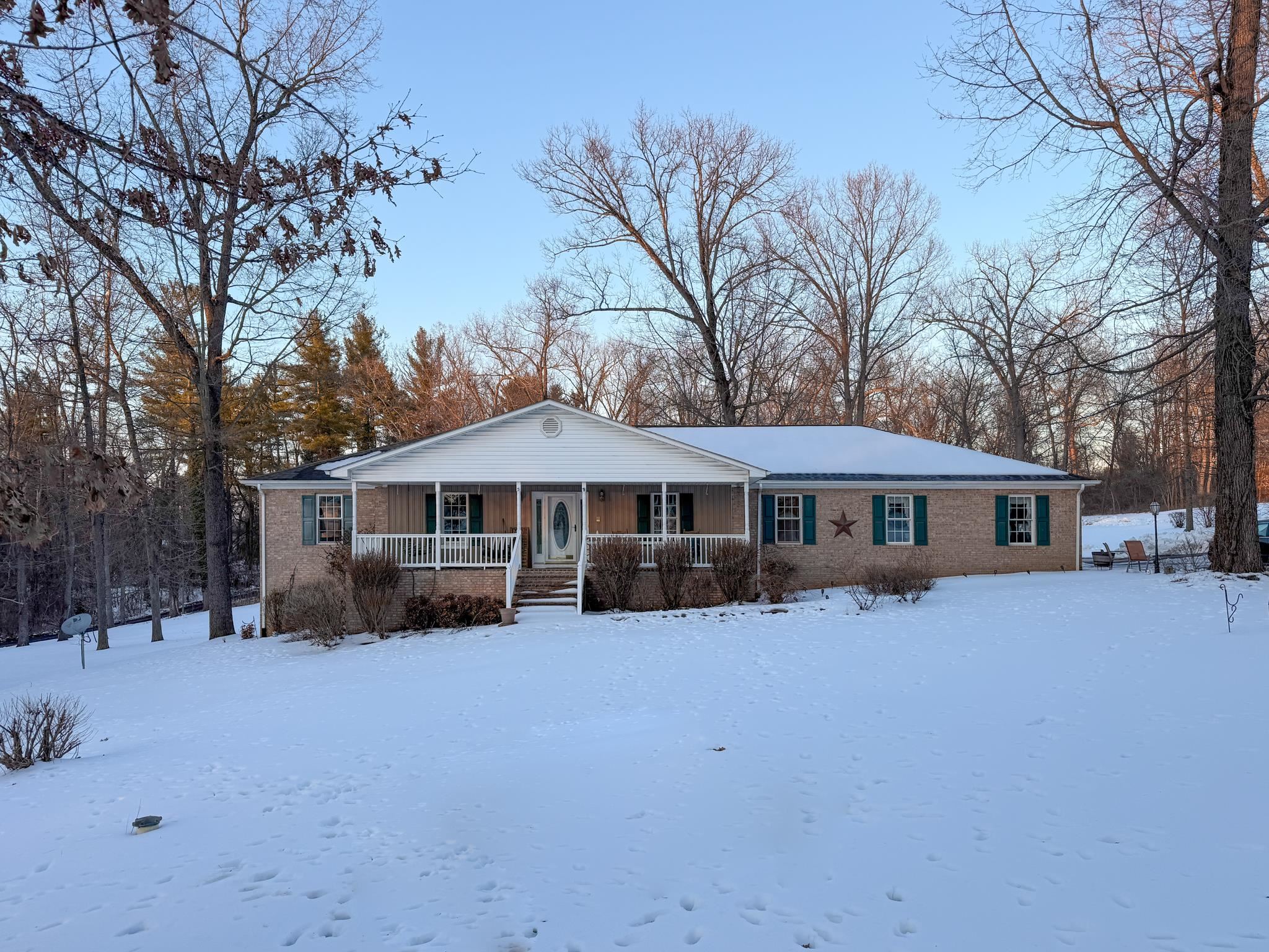 a view of a house with a yard covered with snow in front of house
