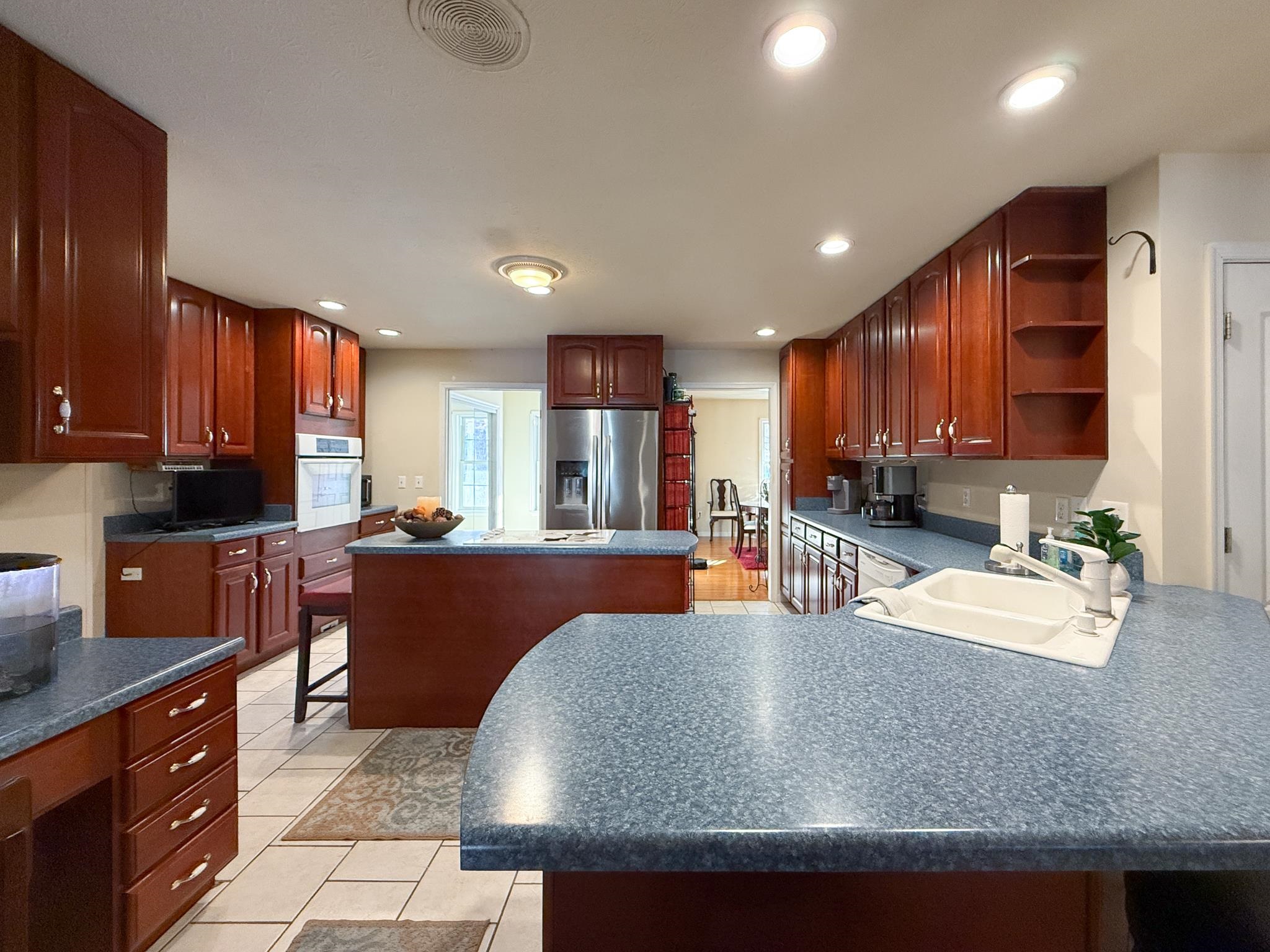 804 Oak Grove Church Road Waynesboro, VA 22980 - Photo 7 of 28 a kitchen with stainless steel appliances granite countertop a refrigerator a sink dishwasher a oven and a large countertops with wooden cabinets