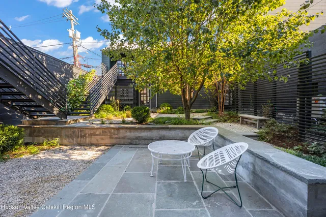 a view of swimming pool with outdoor seating and plants