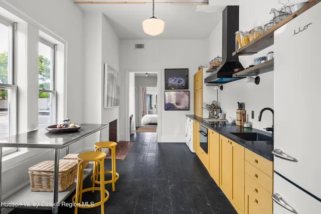 a large kitchen with lots of counter space and windows